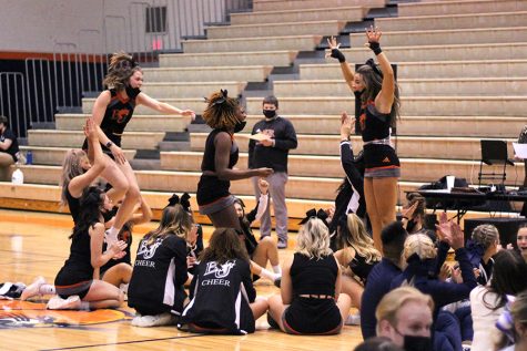 During the awards part of the competition, freshman Ruby Boswell and seniors Sydney Upton and Kira Horn jump up in excitement. The team received their highest score of the season. 