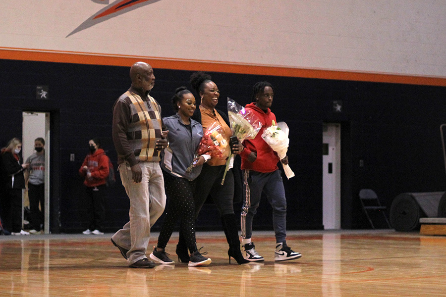 Walking onto the court with her family, senior Payton Johnson gets recognized for her accomplishments during her time at Baker. The Baker Classic was senior night for both the dance and cheer team. 