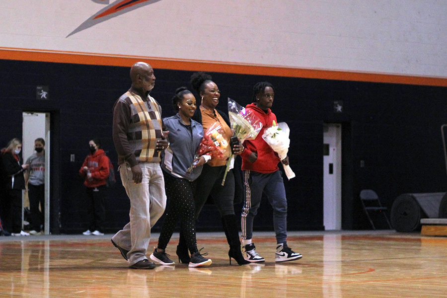 Walking onto the court with her family, Senior Payton Johnson gets recognized for her accomplishments during her time at Baker. The Baker Classic was senior night for both the dance and cheer teams and was held on Feb. 12.