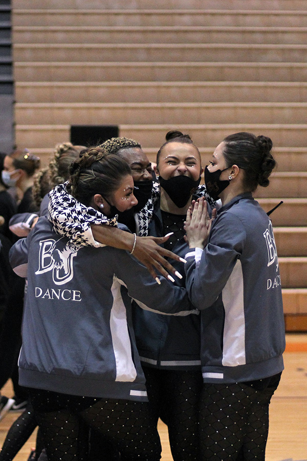 Junior Taylor McEachron, student coach Stephen Long, Senior Kinleigh Brecheisen and Junior Alyssa Waller hug after finding out the team placed first. “I am so proud not only of our wins this season, but of the extreme dedication and hard work this team has put in this year,” Waller said. “This year feels different for us and I can tell we are all willing to put in the extra work to see the results we want.”
