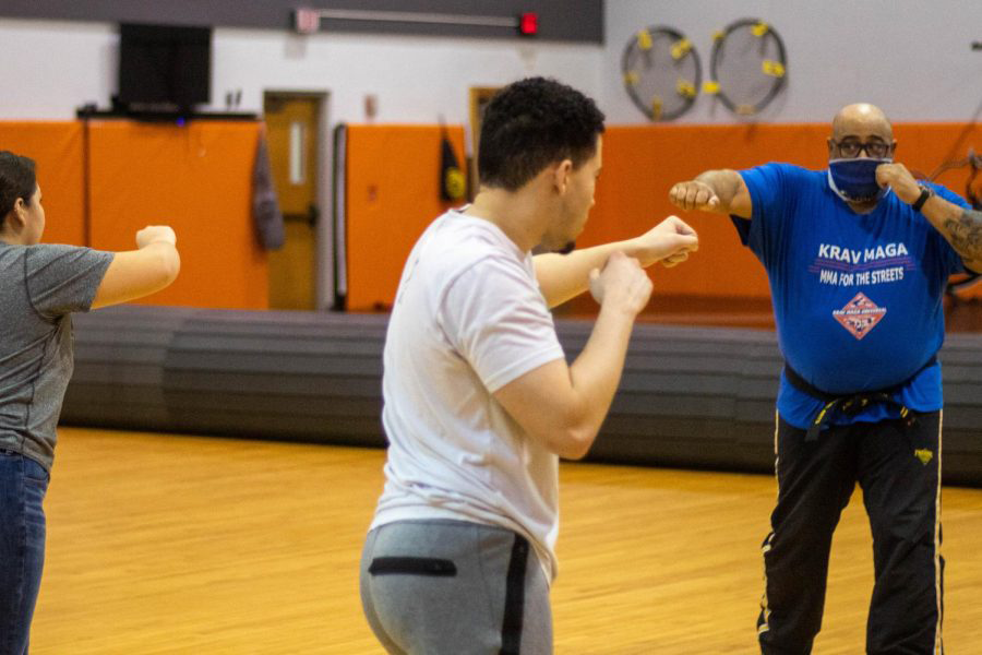 A self defense workshop is held for students on March 9 in Mabee Gym. Andre Smith, program director from Premier Martial Arts, offered instruction on the execution of a proper jab and cross, explaining the importance of hitting with ones two main knuckles.
