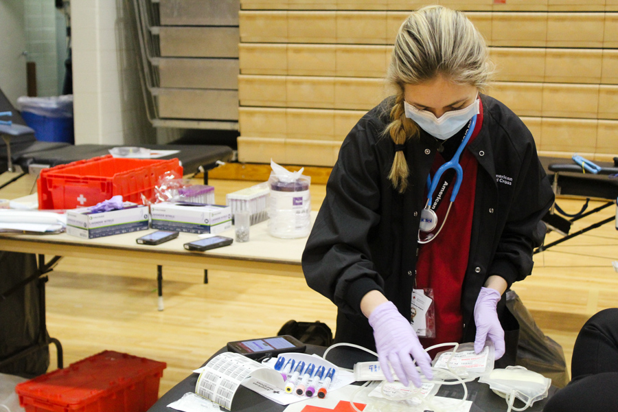 American Red Cross nurse Abby Teschke gathering the equipment needed for the next blood donor. 