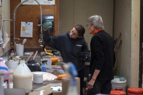 Inge Balch helps senior art student Talon Strouhal with a glaze. This semester marks Balchs final one at Baker.