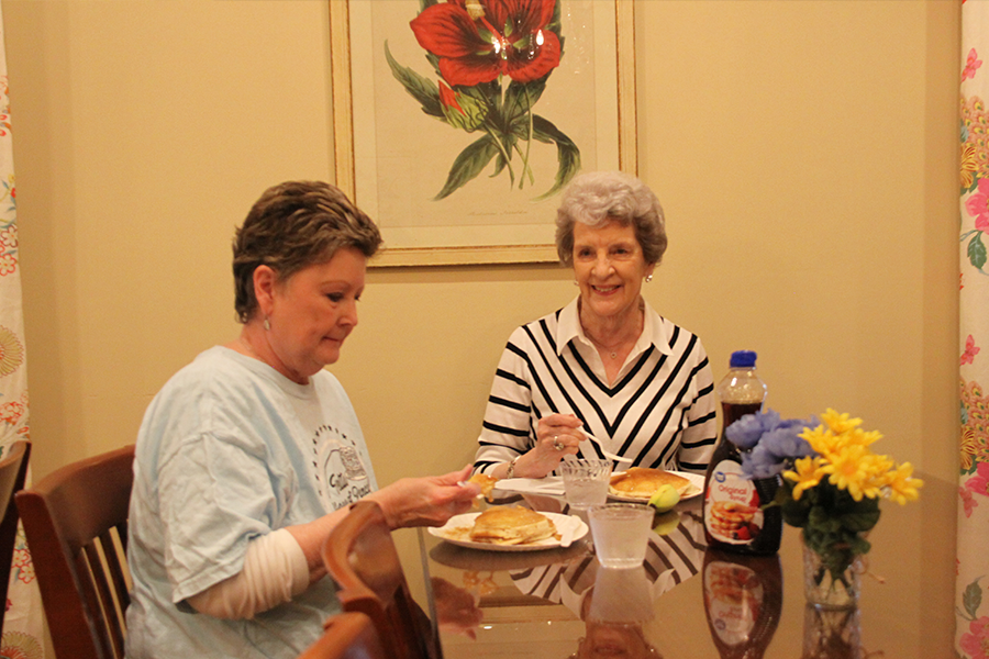 Tri Delta House Mother Lynette Lloyd (left) and Tri Delta alum Susanne Teel (right) enjoy their pancakes. Along with providing pancakes, a variety of toppings including whipped cream, sprinkles, bananas and peanut butter were available.