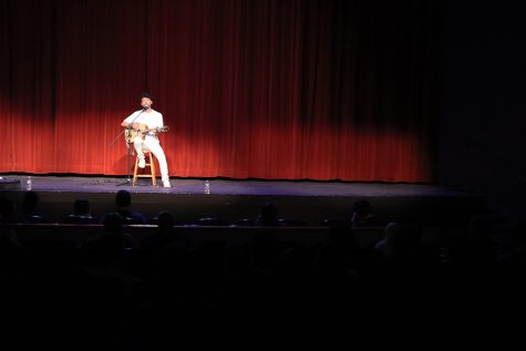 Strumming on his guitar, comedian and musician Morgan Jay plays for Baker students in Rice Auditorium on Oct 4. 