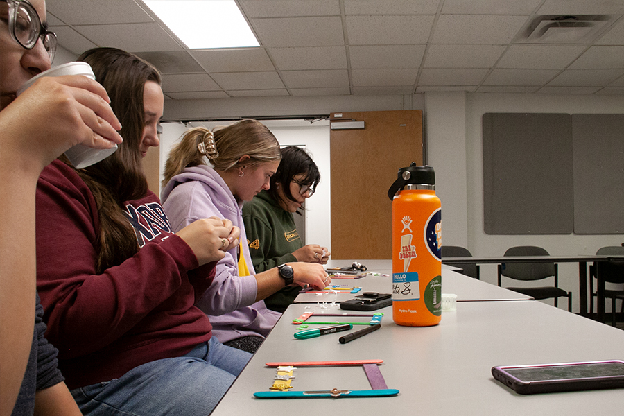 Junior Kiley Jenkins and her Tri-Delta sisters worked on decorating frames for the ofrenda. Jenkins makes a frame for another student who might need one. 