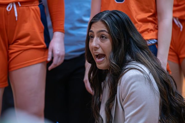 Head Coach Torie Murillo talks to her team during a timeout in the second half.