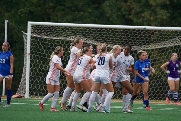 Junior Caitlin Youles celebrates with the team after scoring the first goal of the game. 