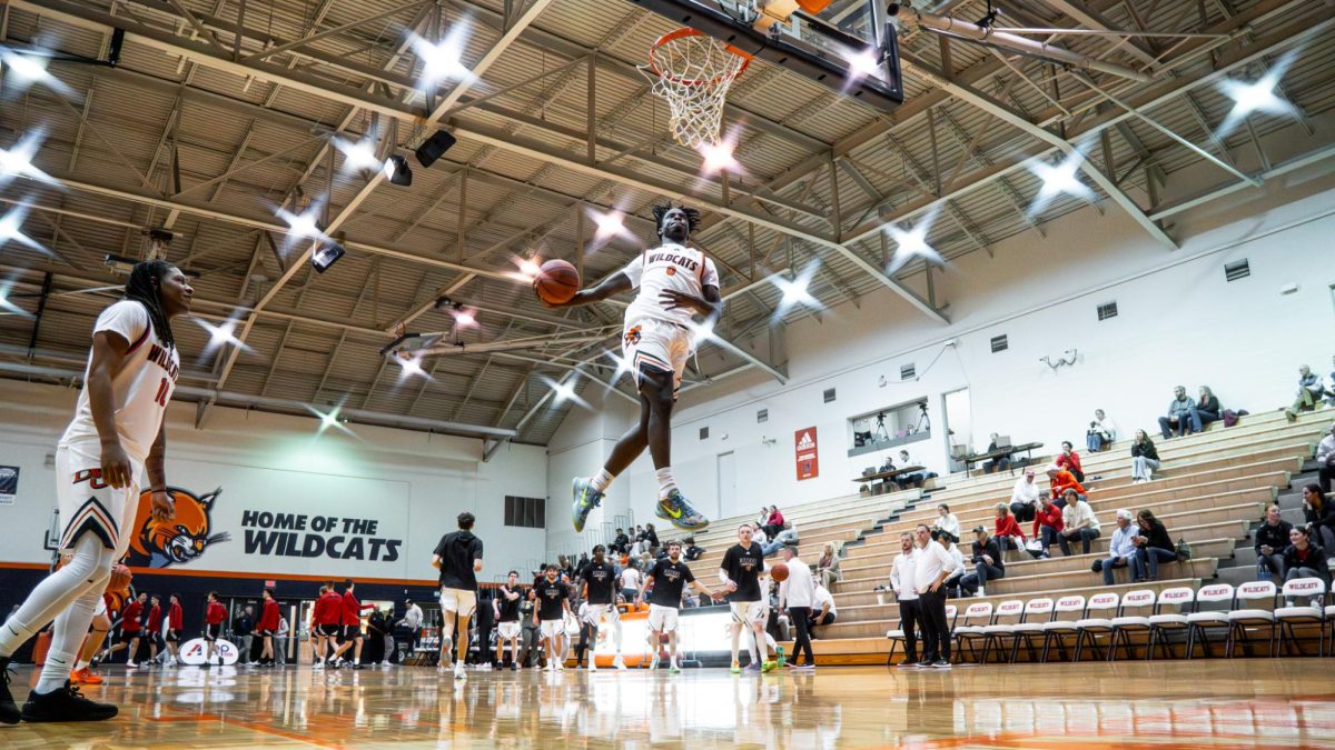 Myles Tucker (#0) takes flight during warm-ups before the matchup with Benedictine.