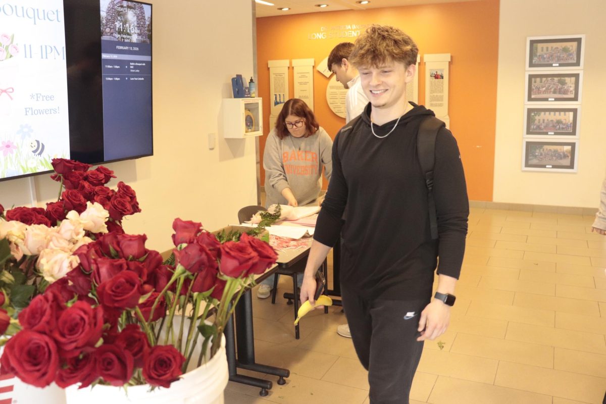 Jack Meylan approaches Student Activity Council's table to create a flower bouquet. 